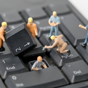 regclean pro registry cleaners features tiny working men figurines toys working on computer keyboard